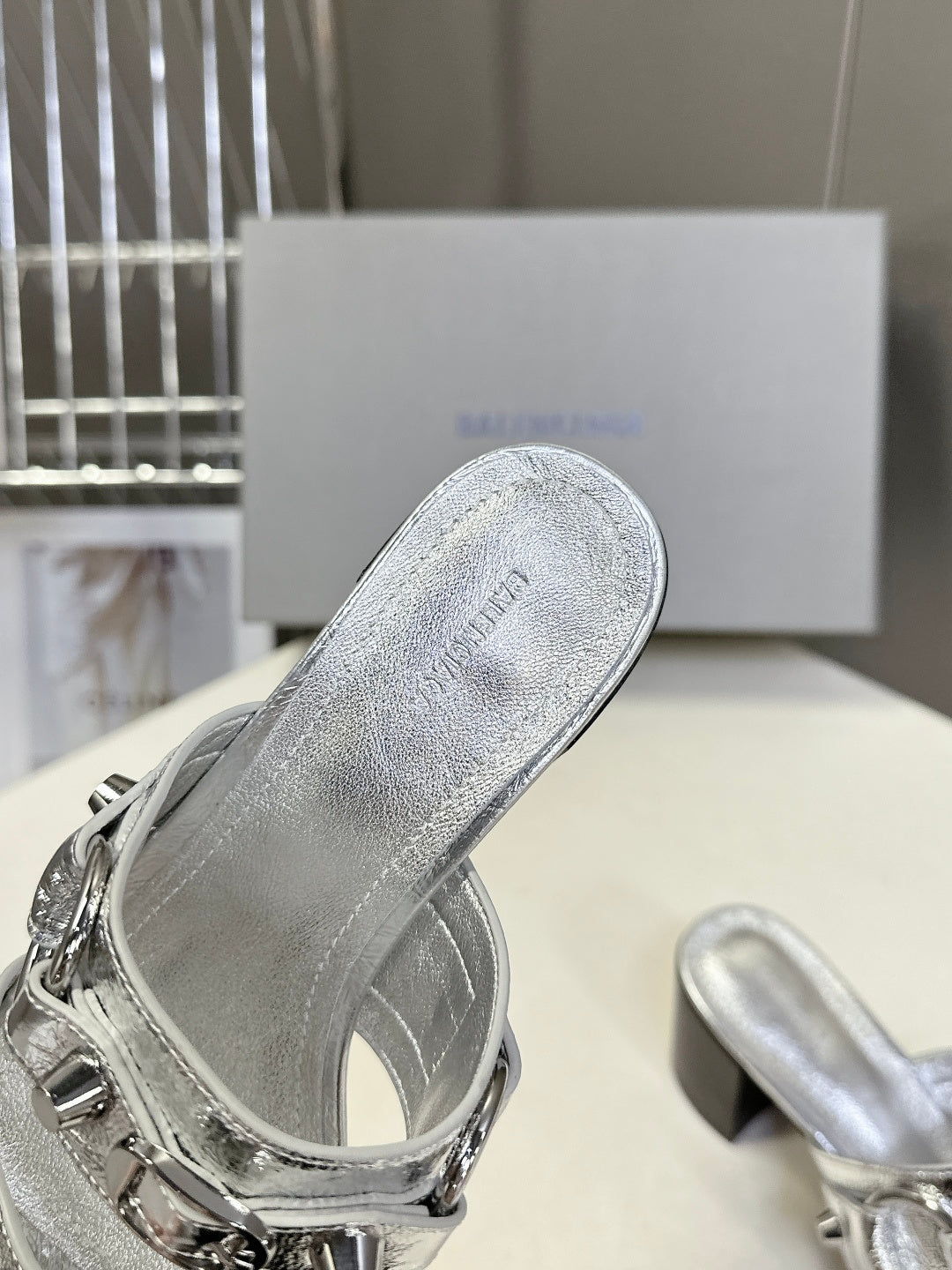 Silver slide sandal with engraved insole text and silver buckle strap