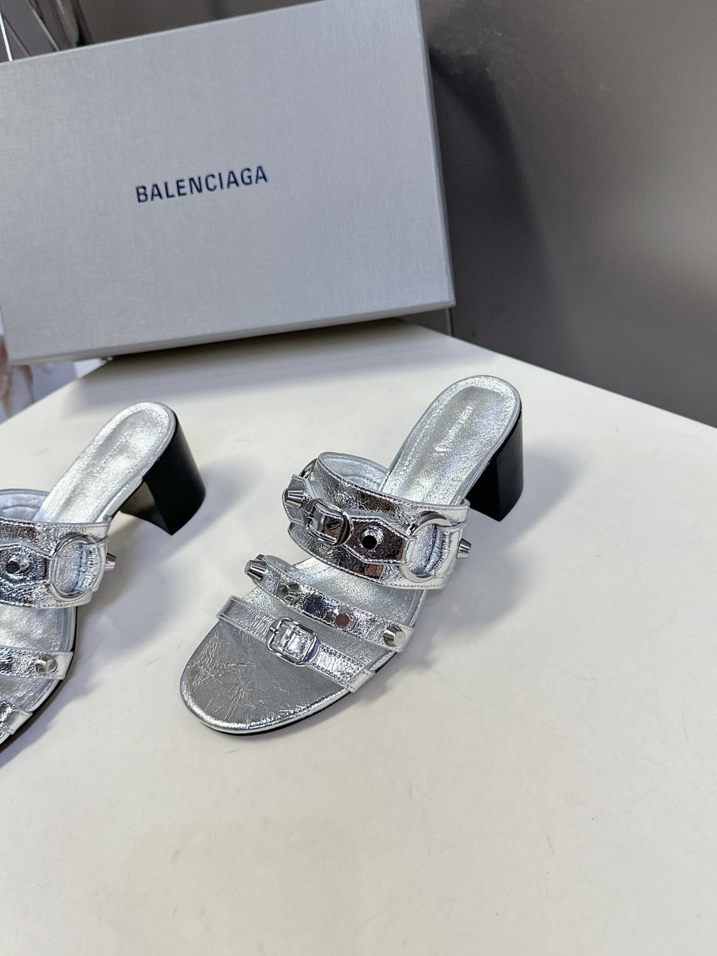Silver slide sandals with double buckle straps and black block heel