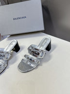 Silver slide sandals with double buckle straps and black block heel