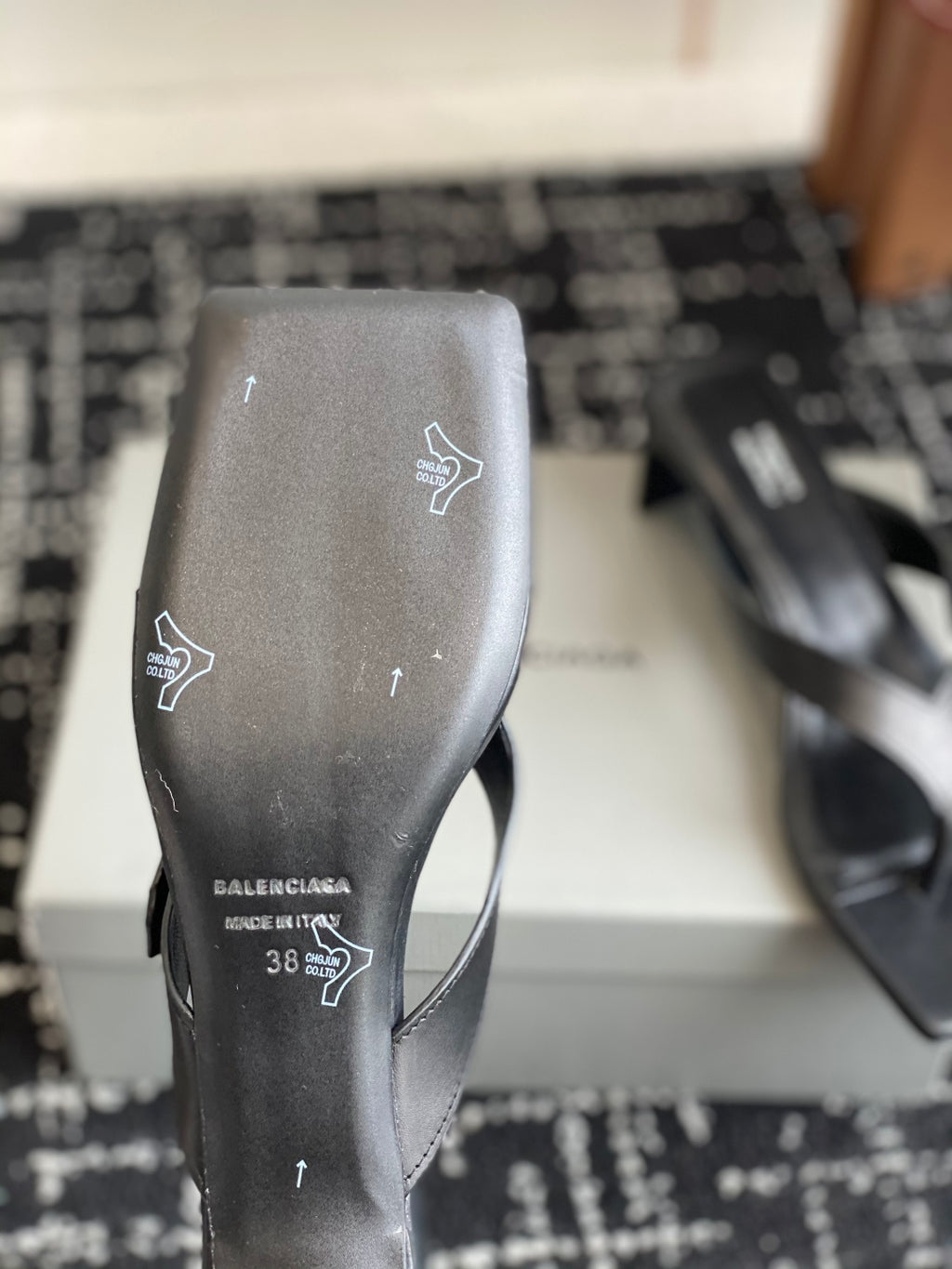 Balenciaga sandal sole view, dark leather upper with branding and size markings
