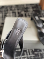 Balenciaga sandal footbed in dark leather with embossed brand text, side view