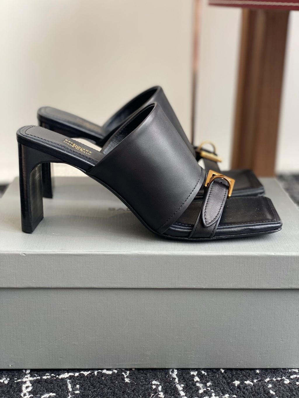 Balenciaga black leather slide sandals with tall block heel and gold buckle