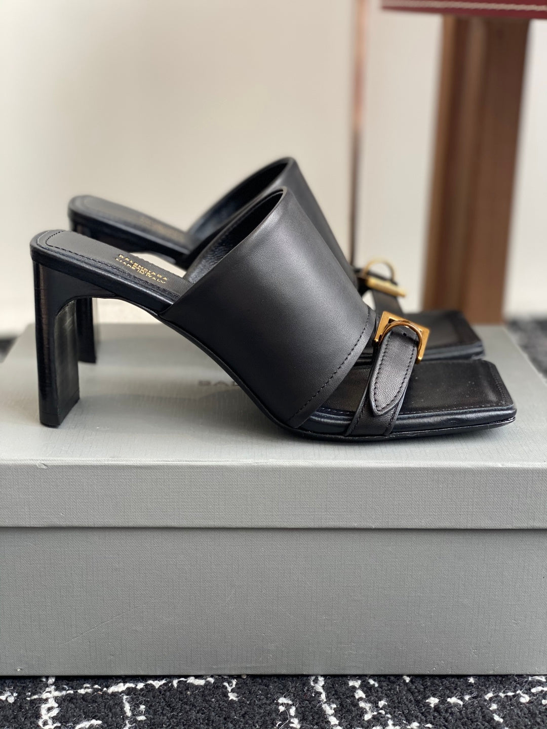 Balenciaga black leather slide sandals with tall block heel and gold buckle