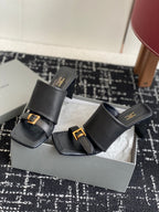 Balenciaga black heeled mule sandals with front strap and gold buckle details