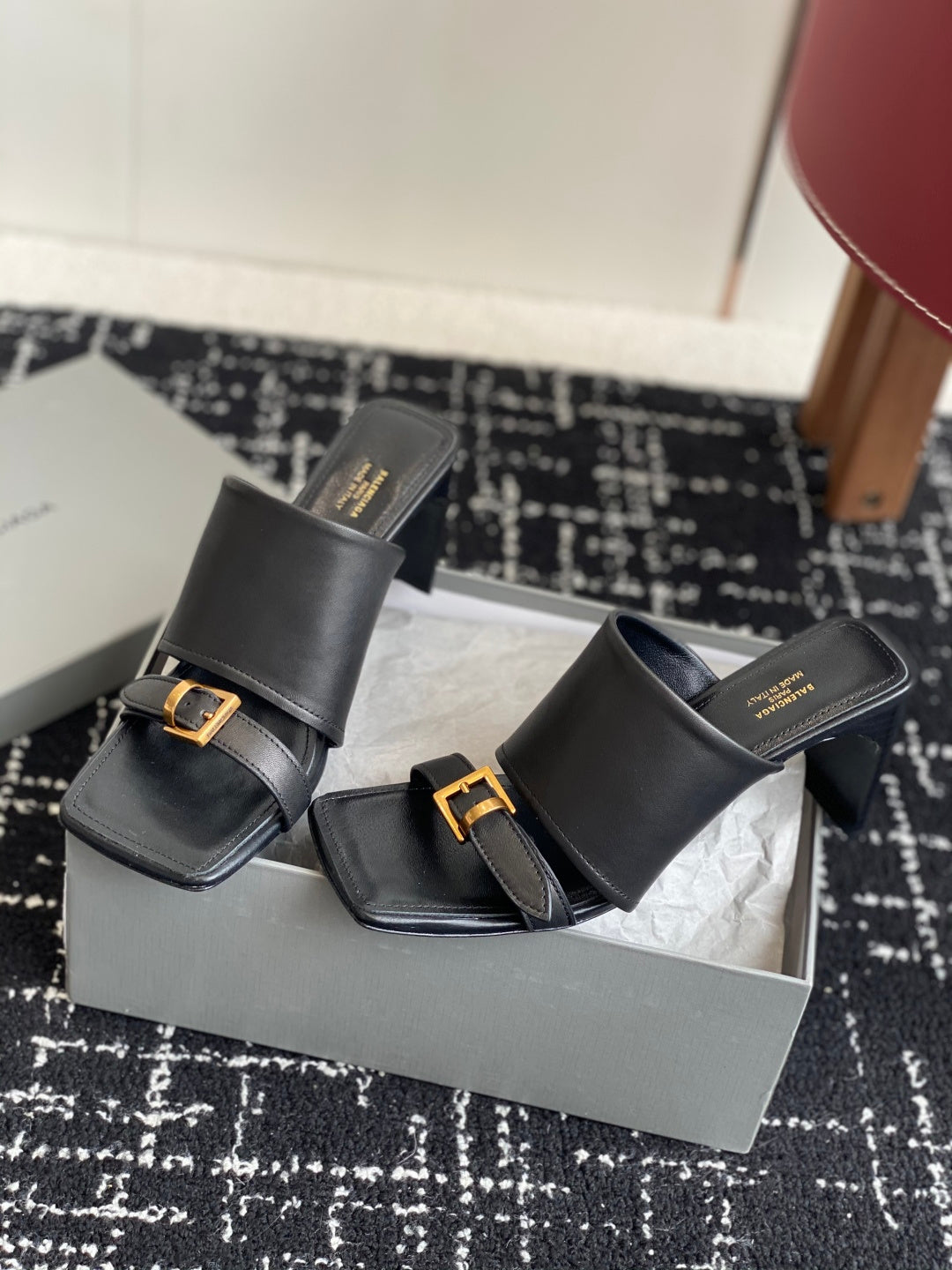 Balenciaga black heeled mule sandals with front strap and gold buckle details