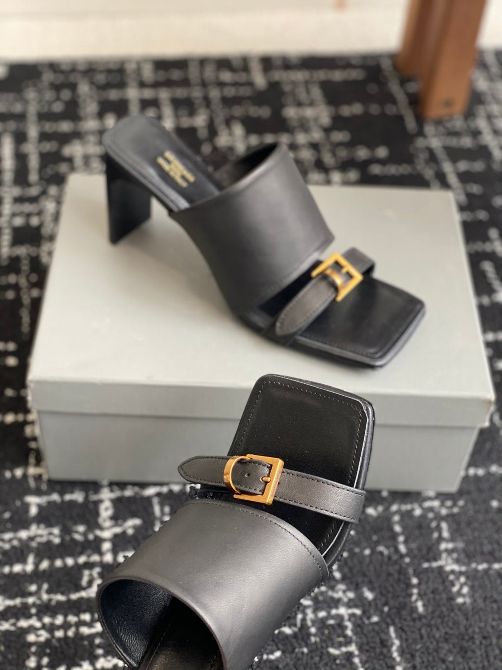 Balenciaga black heeled mules with side strap and square gold buckle
