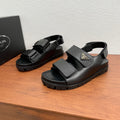Prada unisex sandals in black leather with double adjustable straps and chunky tread sole