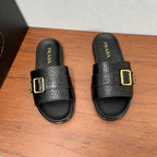 Prada black slide sandals with gold buckle and molded footbed