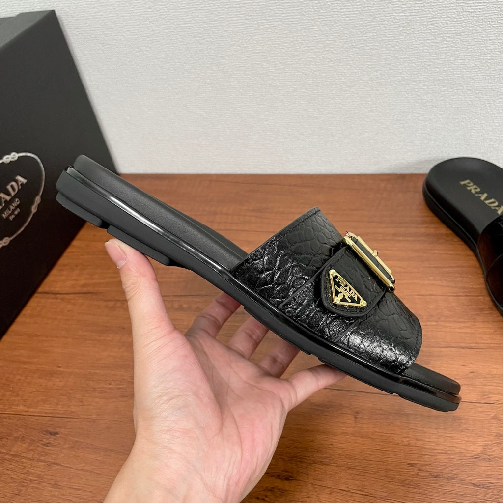 Prada black slide sandal with gold buckle strap and thick rubber sole