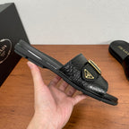 Prada black slide sandal with gold buckle strap and thick rubber sole