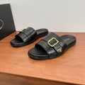 Prada black leather-look slide sandals with gold square buckle