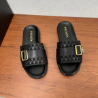 Black Prada slide sandals with wide strap and gold buckle, front view.