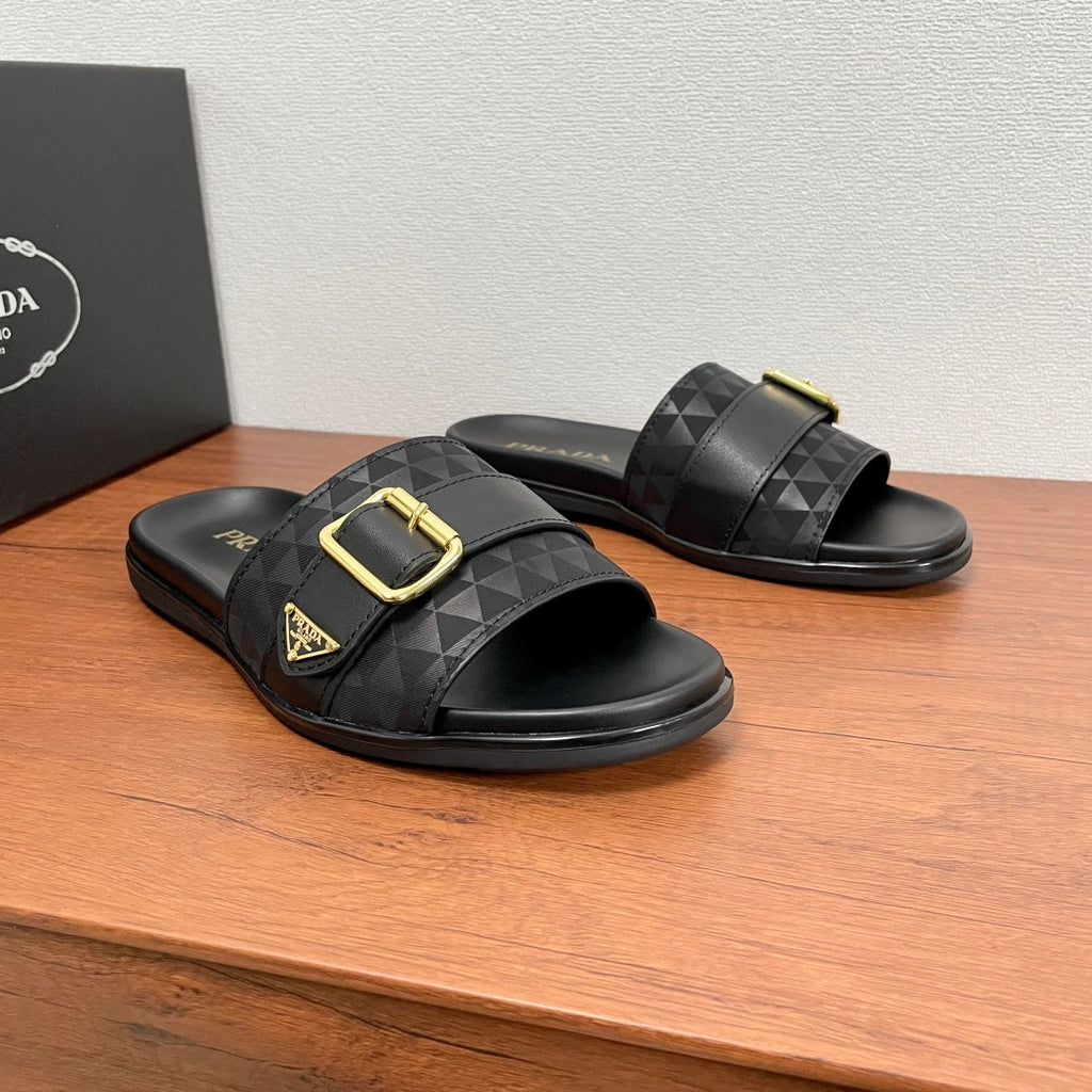 Black Prada slide sandals with geometric inlay straps and gold buckle, side angle.