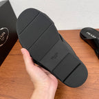 Black rubber outsole for slide sandals with textured tread and brand markings