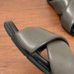 Gray Prada slide sandal side view, wide strap and black rubber sole