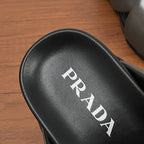 Black leather footbed with PRADA logo lettering on Prada slide sandal