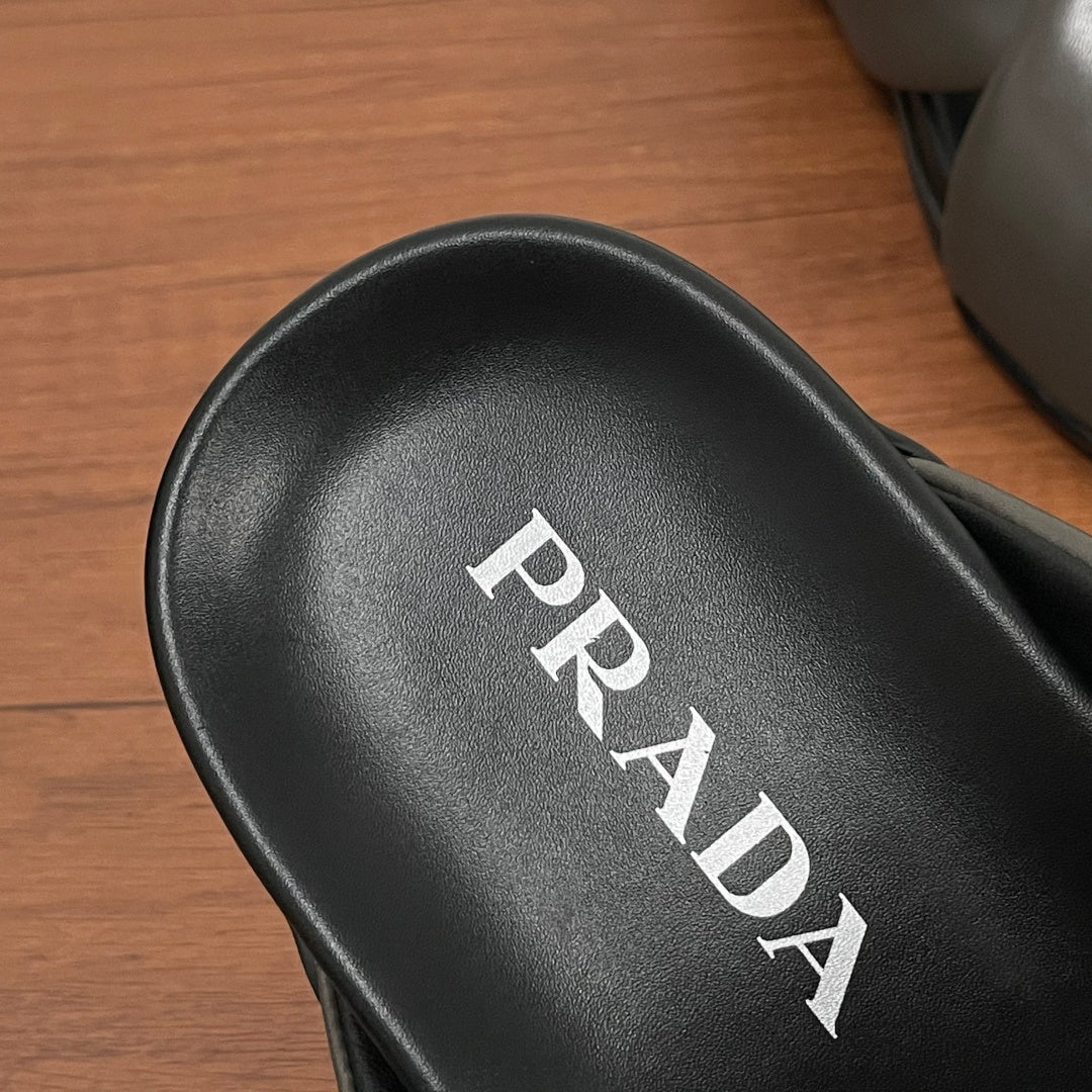 Black leather footbed with PRADA logo lettering on Prada slide sandal