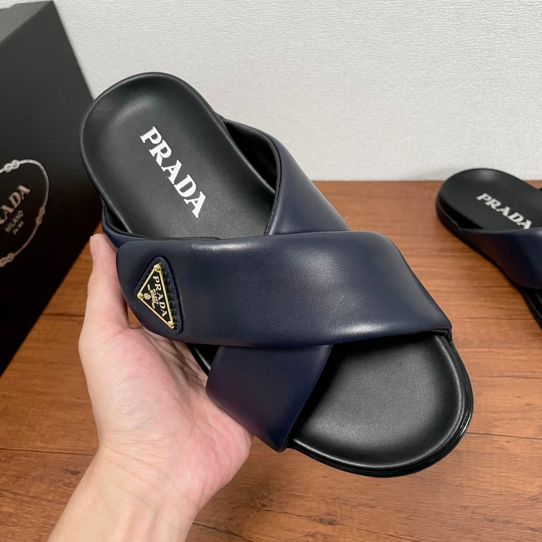Prada navy slide sandal front view, PRADA on footbed, black sole