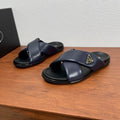 Prada navy slide sandals with wide cross straps and black rubber sole