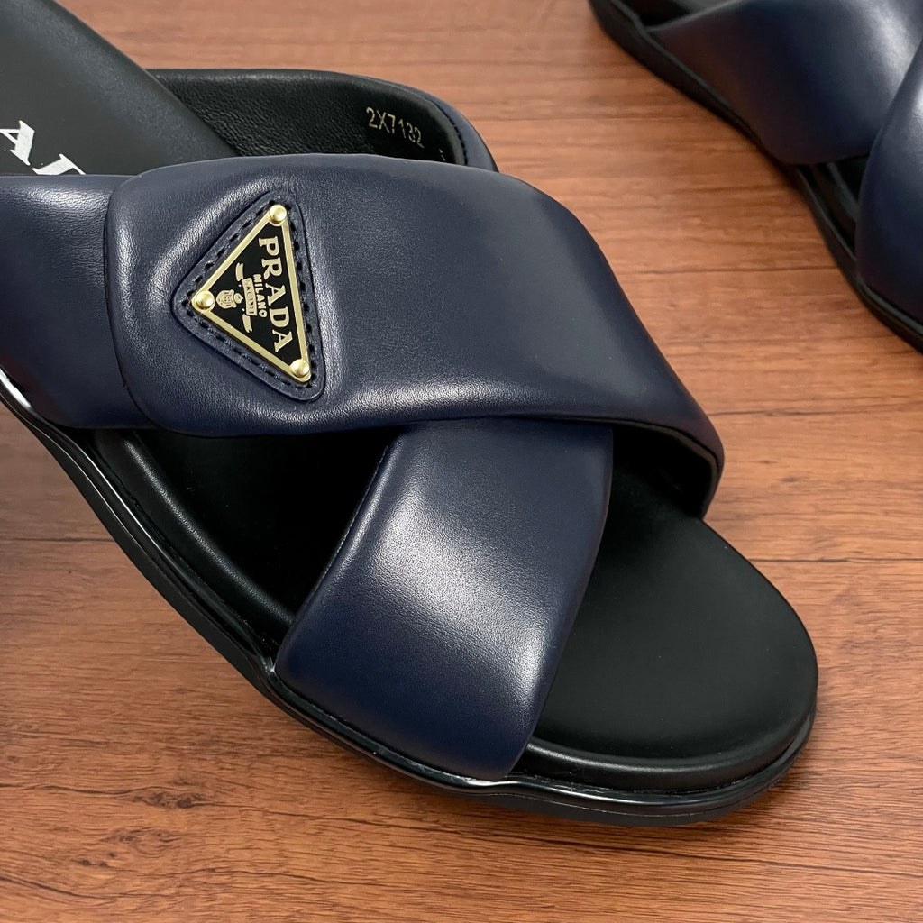 Prada navy leather slide sandal with gold-trim logo plaque and black sole