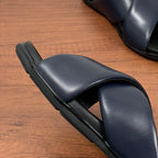 Prada navy slide sandal side view with contoured footbed and rubber sole
