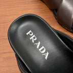 Black leather footbed with white PRADA lettering on slide sandal