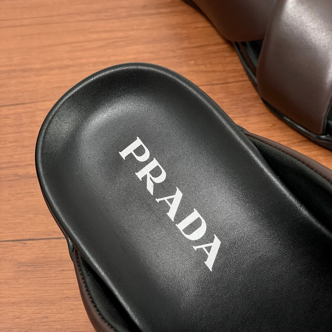 Black leather footbed with white PRADA lettering on slide sandal