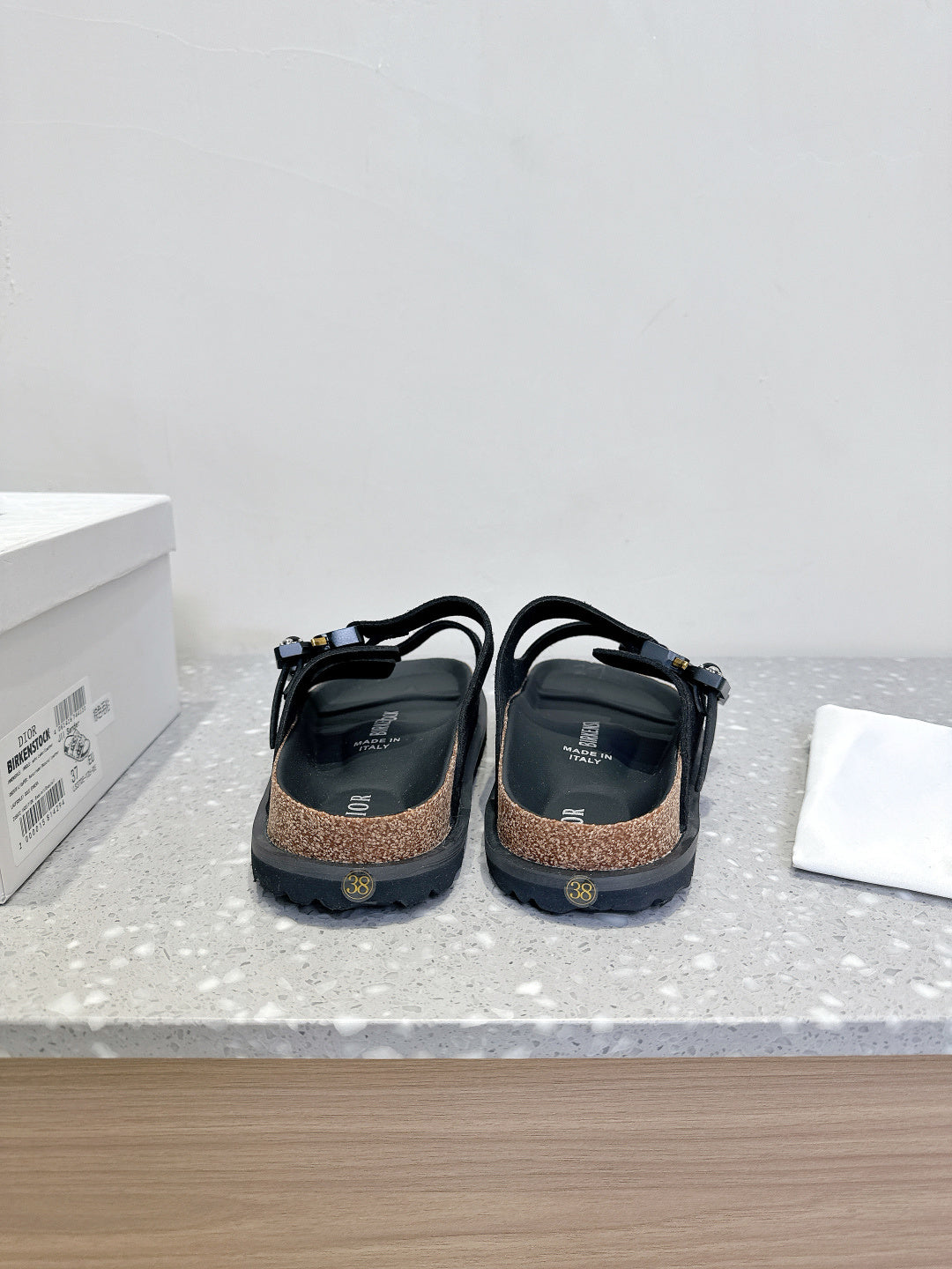 Dior sandals back view, black straps and heel counters with cork-look footbed