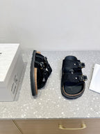 Dior sandals, side view, black strap with metal buckle and cork-look sole