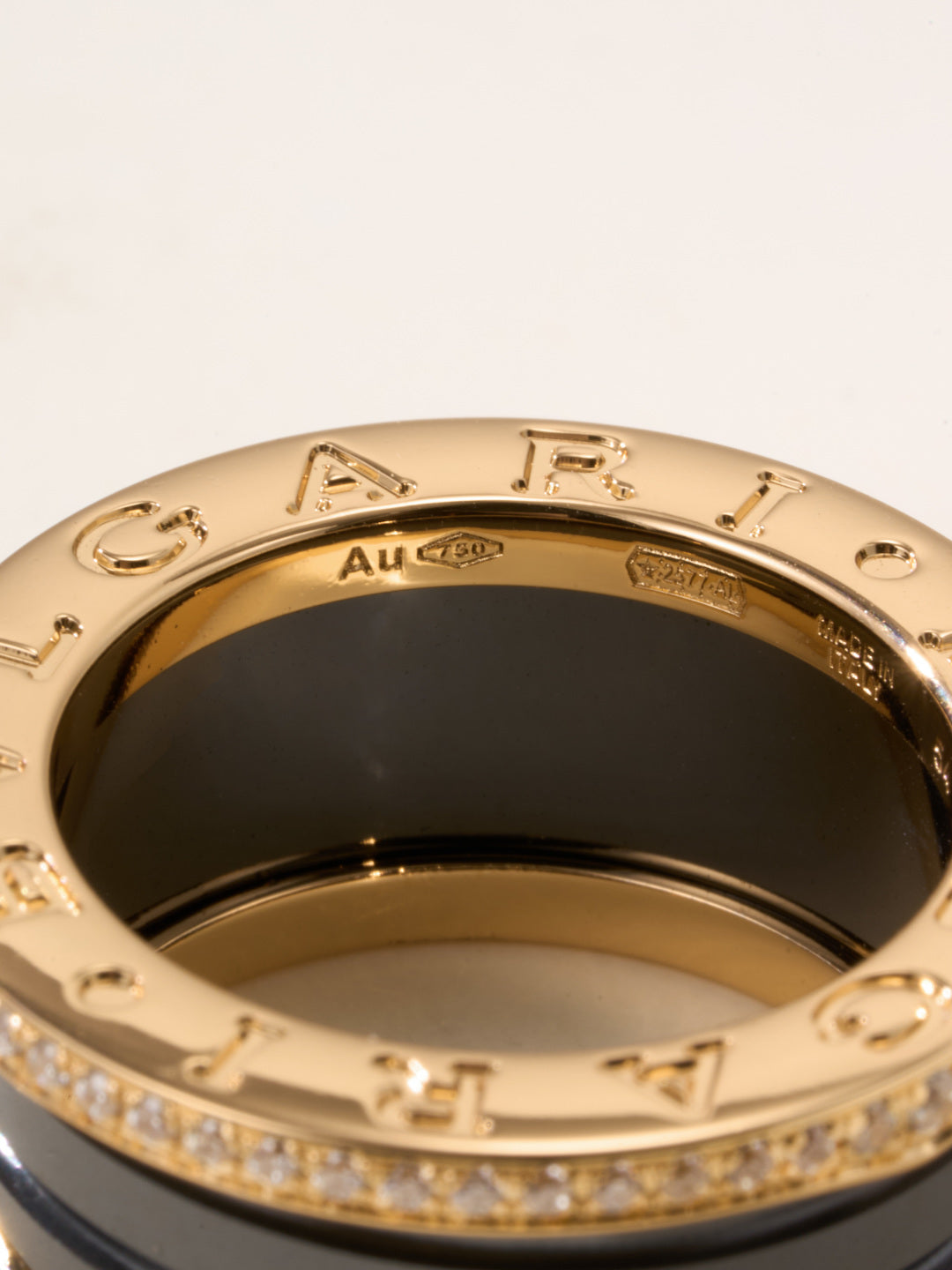 Gold ring interior with engraved letters and dark lining, close-up