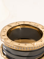 Gold-tone ring inner view with engraved markings and dark enamel center