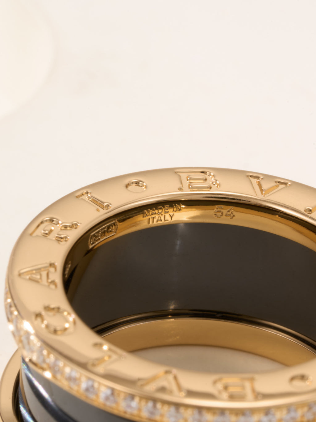 Gold-tone ring interior showing “ITALY 54” engraving and pavé stones