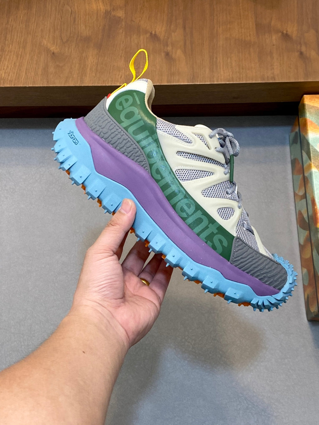 Moncler sneakers side view in gray and purple with green stripe and blue sole