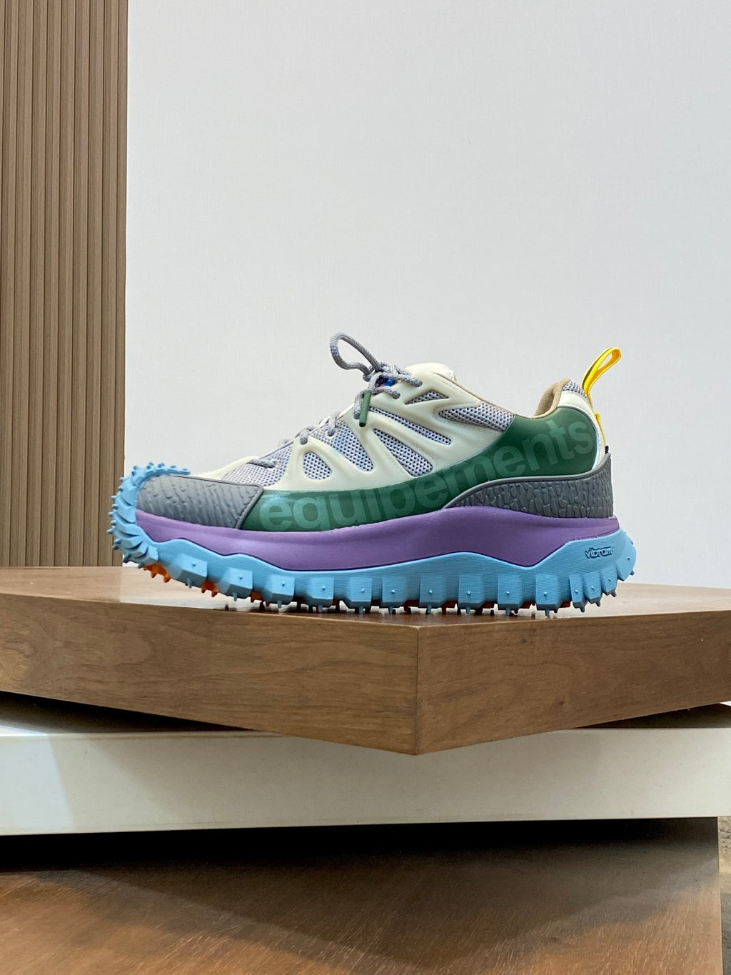 Moncler sneakers with white uppers, green accents, and blue sole with tread