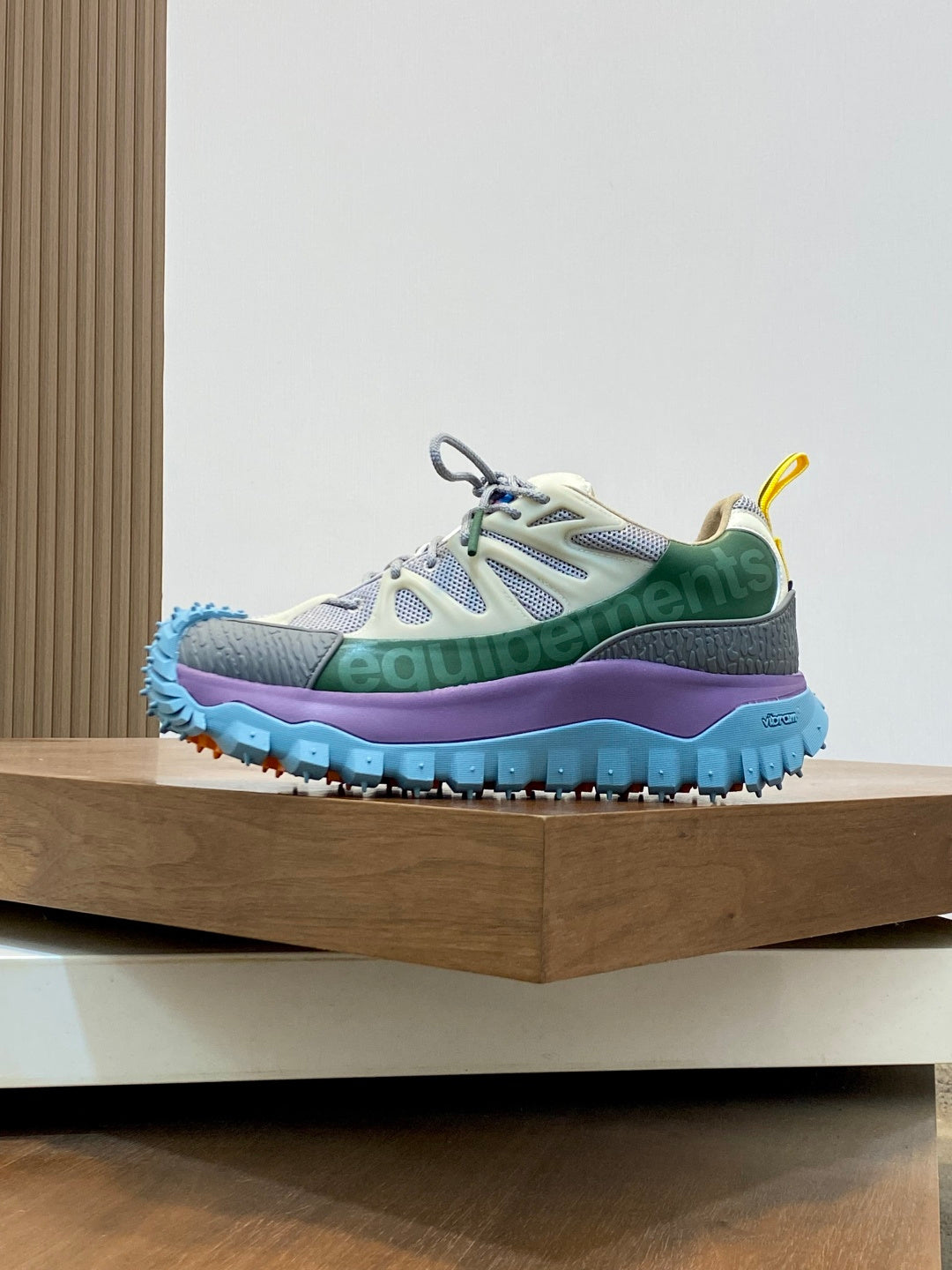 Moncler sneakers with white uppers, green accents, and blue sole with tread