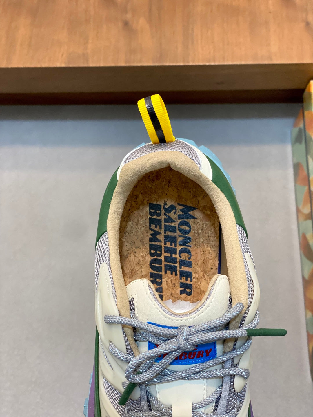 Moncler sneakers close-up of lace-up front with yellow loop and patterned heel