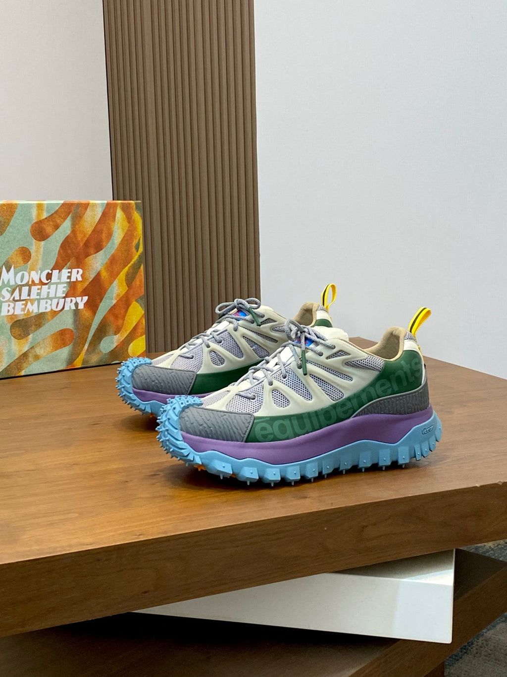 Moncler sneakers with white upper, green and purple panels, and blue textured sole