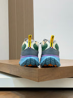 Moncler sneakers back view with purple heel, green accents, and blue sole