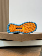 Moncler sneaker outsole in orange with blue tread pattern