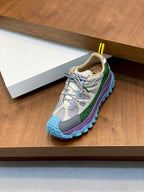 Moncler sneakers with gray upper, green stripe, and blue treaded sole