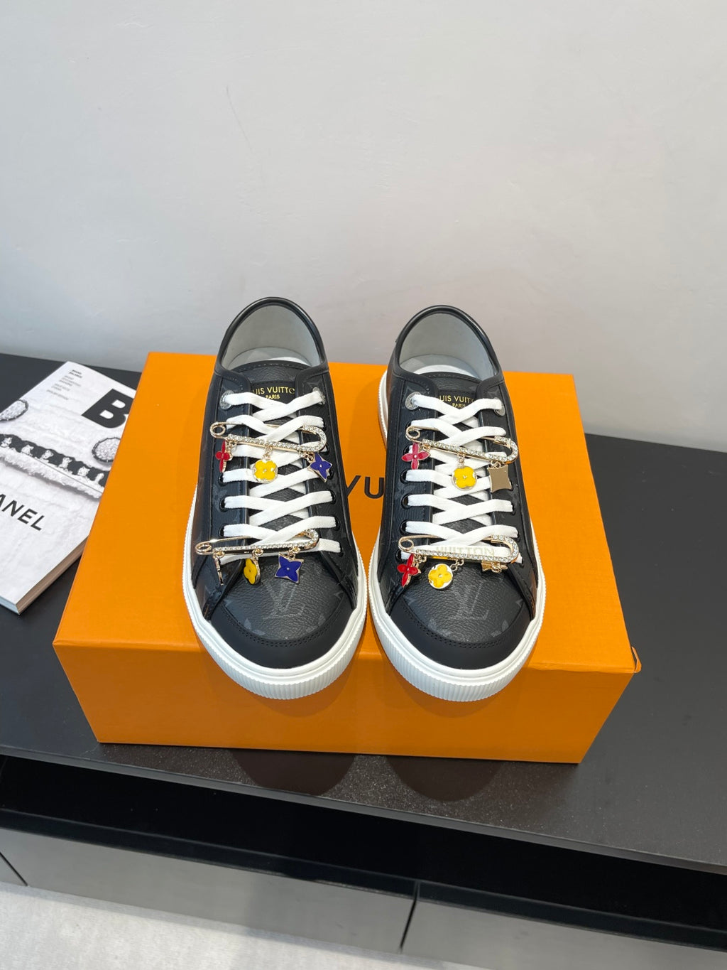 Louis Vuitton low-top sneakers in dark fabric with white laces and colorful charm accents