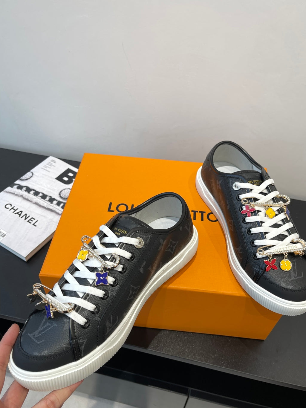 Louis Vuitton low-top sneakers in dark monogram with white laces and dangling charms
