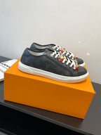 Louis Vuitton low-top sneaker, dark monogram canvas with white laces and colorful details