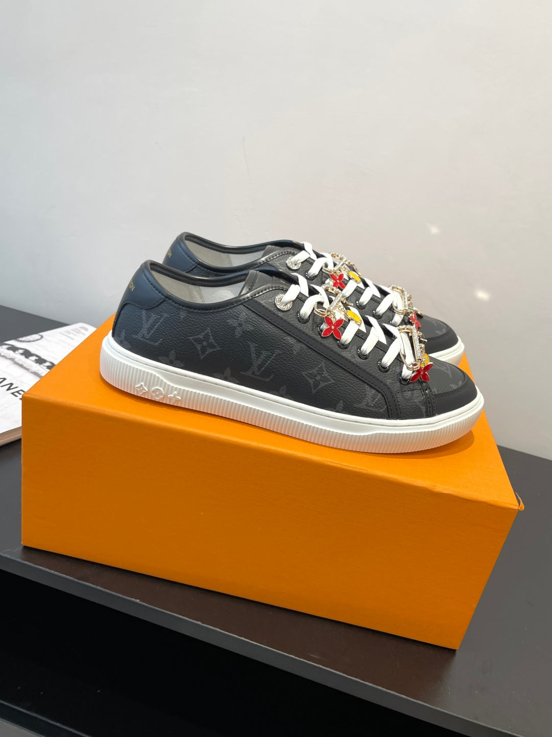 Louis Vuitton low-top sneaker, dark monogram canvas with white laces and colorful details