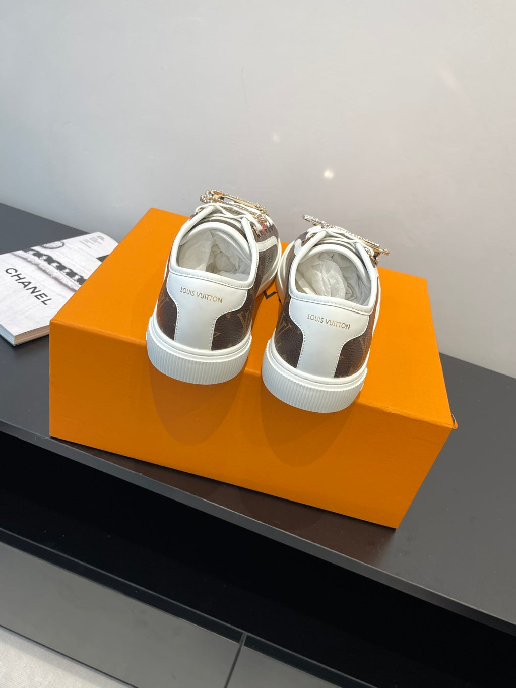 Louis Vuitton sneakers from back view with white rubber sole and brown monogram panels