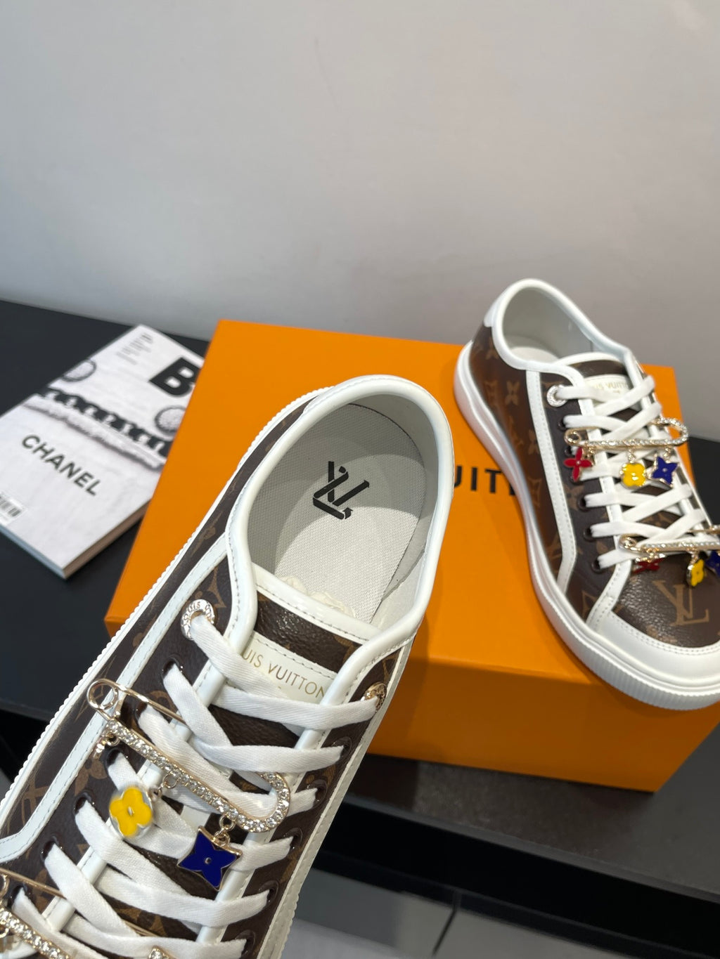 Louis Vuitton sneakers showing lace eyelets and brown monogram side panel with white sole