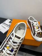 Louis Vuitton sneakers showing lace eyelets and brown monogram side panel with white sole