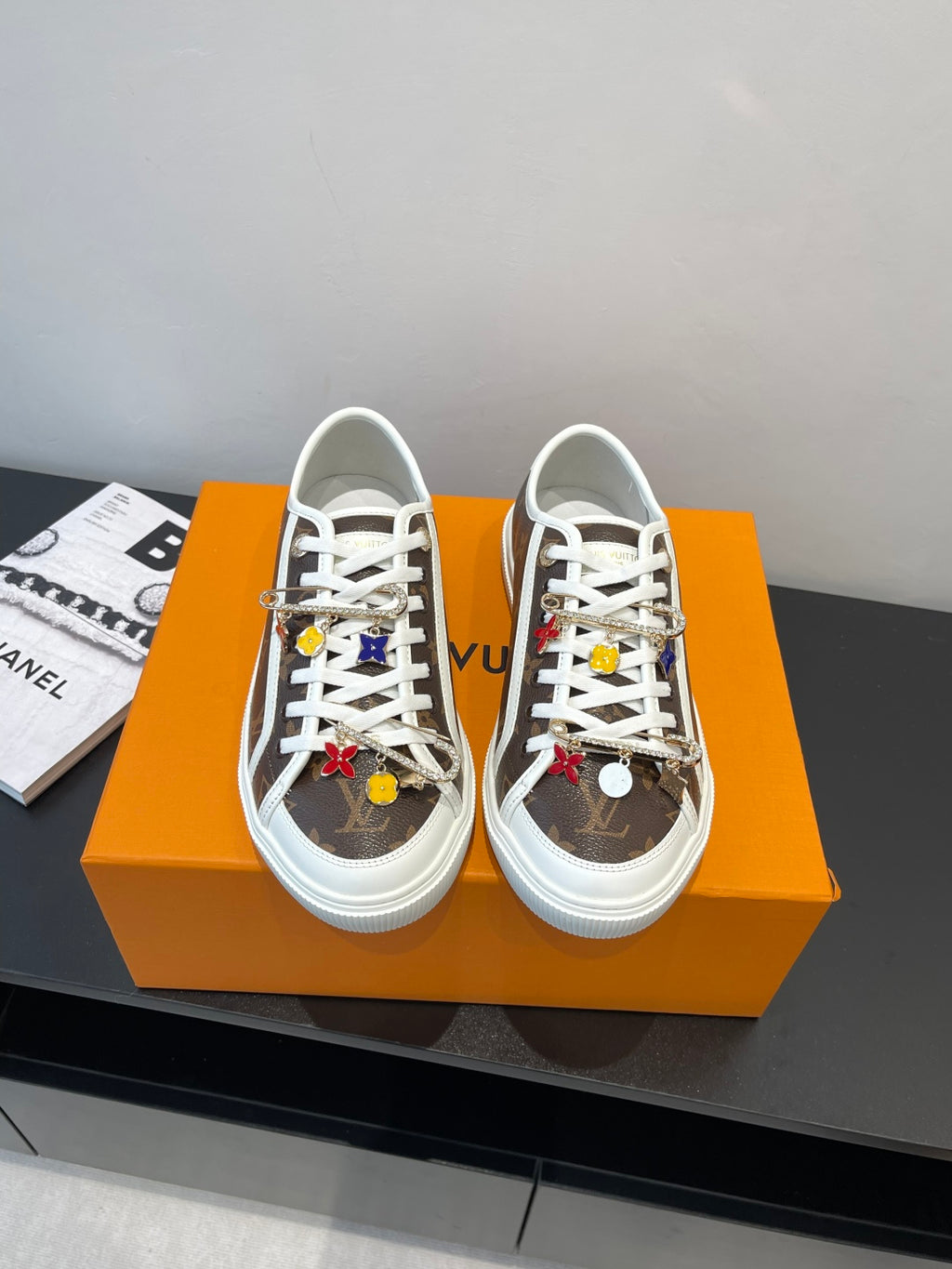 Low-top Louis Vuitton sneakers with white laces, brown monogram uppers, white rubber sole
