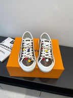 Low-top Louis Vuitton sneakers with white laces, brown monogram uppers, white rubber sole