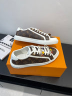 Louis Vuitton low-top sneakers with brown monogram upper, white laces, and white rubber sole